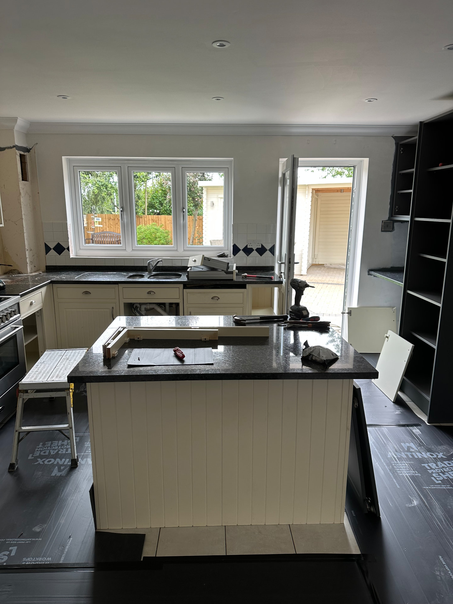 The original kitchen before removal, floor protected for the rip out