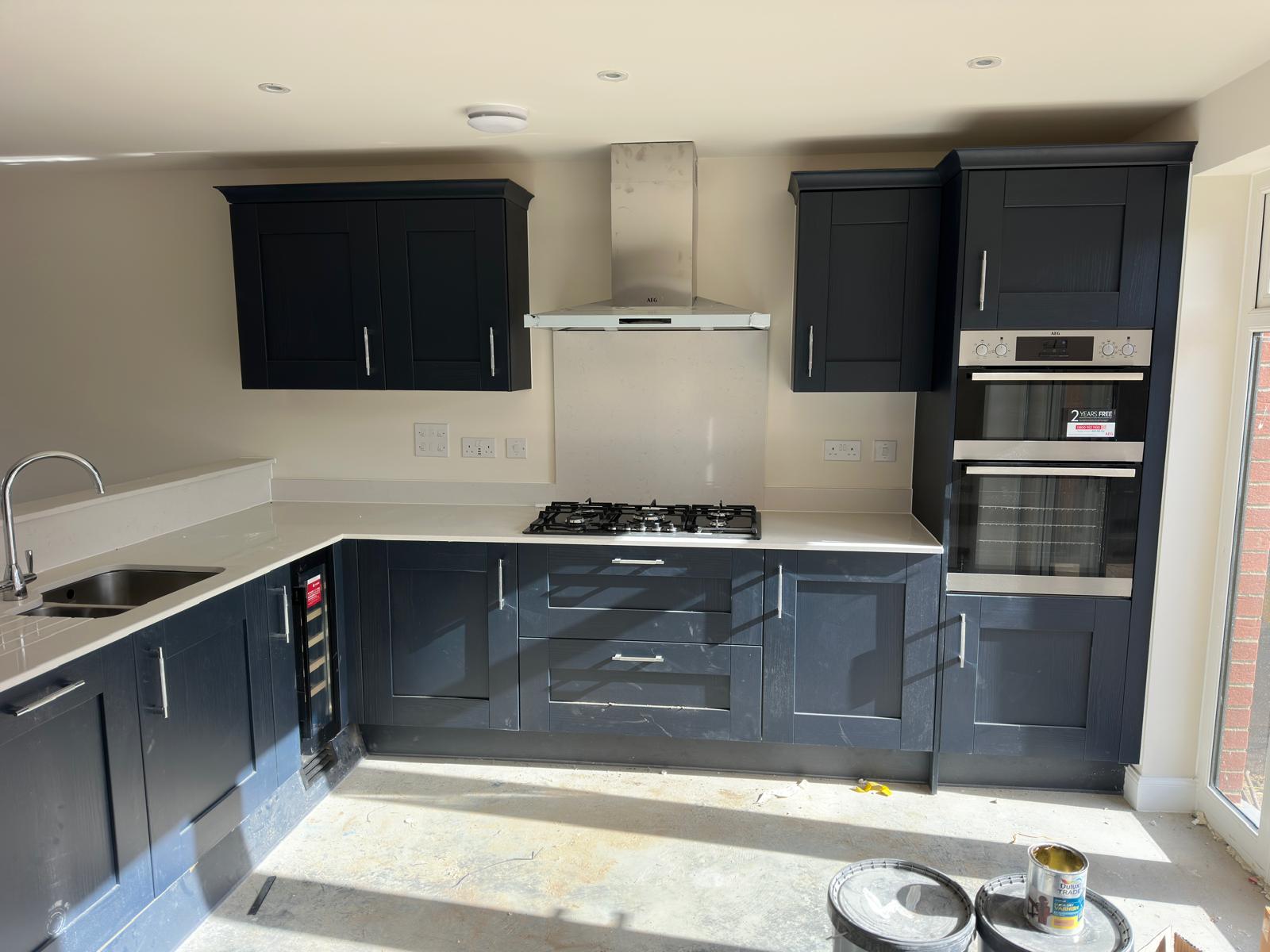 Charcoal painted kitchen with integrated appliances and wine cooler