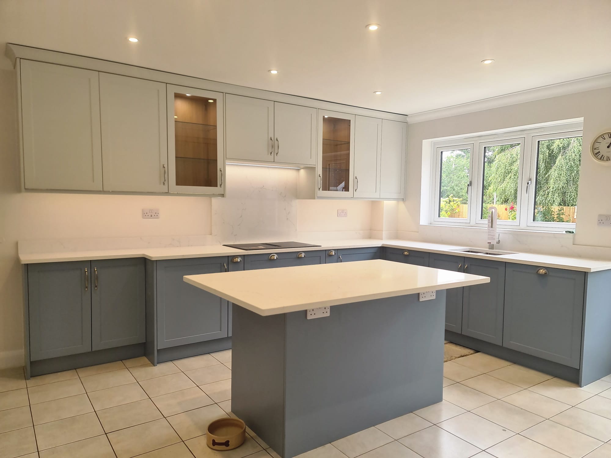 The completed hand painted kitchen with glazed wall cabinets and island